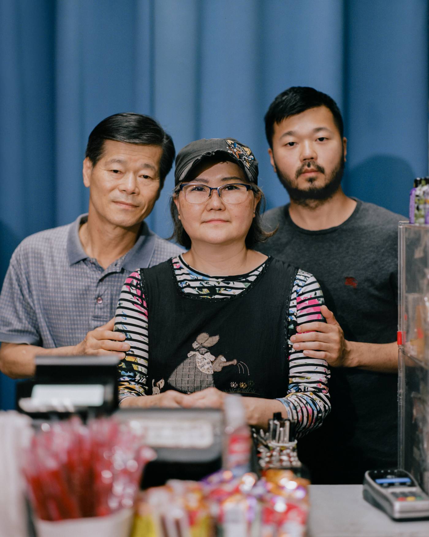 'I STILL WISH FOR A BETTER LIFE.' Mun Sung, left, and Joyce Sung, center, stand with their 35-year-old son Mark Sung, right, in the family’s Charlotte, N.C., convenience store on May 29. The elder Sungs watched helplessly on March 30 as a man smashed through glass with a metal pole, ripped down racks and hurled racial slurs at them inside the store they’ve owned for two decades. Despite facing racism at work on a daily basis since the pandemic began—even growing hardened to the hatred month after month—Mun never expected his family would fall victim to such violence. “I feel so terribly bad,” the 65-year-old says, “because how can people do that to us?” Less than two months later, it happened again. On May 25, after being told he did not have enough money for cigarettes, a customer shouted racial slurs as he pummeled a sheet of plexiglass at the checkout counter until it shattered on Joyce, 63, bruising her forehead. “Knowing that we’re going to get cursed out every day while we’re getting ready for work,” she says, pausing to think, “we don’t know what words to use.” The family has few other options. The pandemic drove down sales at the store by about 45%—and all their employees quit over safety concerns—so the Sungs say they don’t have the luxury to stop working. Instead, they clock in 13-hour days, seven days a week, and have developed a routine for responding to hate: call the police, assess the damage, file an insurance claim, then go back to work. It’s not the life Mun imagined for himself or his family when he left South Korea for the U.S. in 1983. But he and Joyce keep going, in large part to have some money to leave for Mark’s two toddlers, their only grandchildren. “The first time I came to the United States, I had big dreams and high hopes,” Mun says. “I didn’t make it, but I still wish for a better life.”